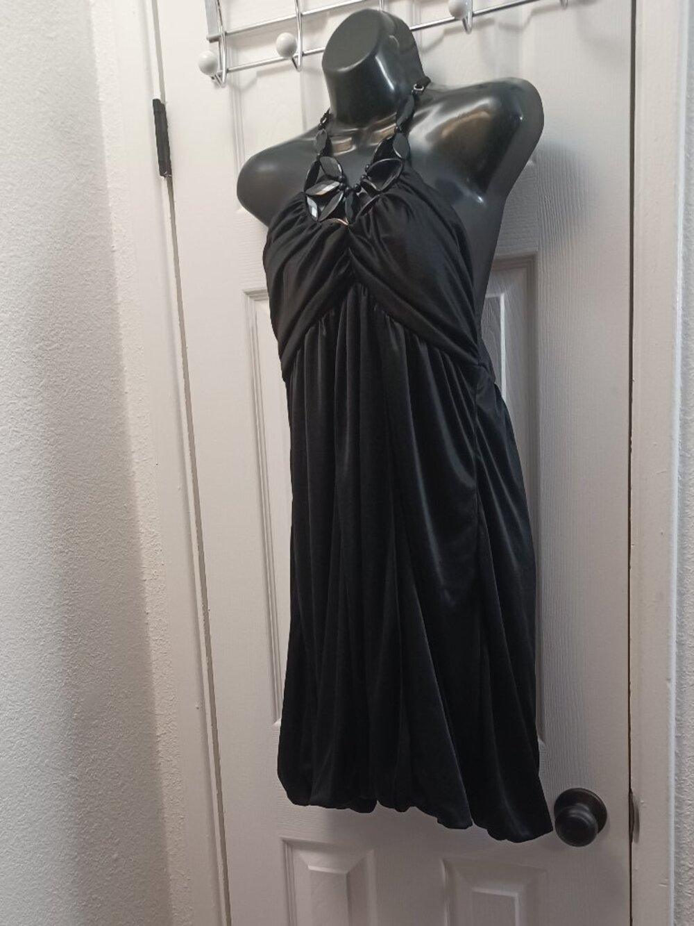 Black halter neck dress babydoll style with leaf-shaped cutouts and beads #halte